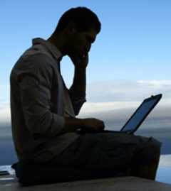 Man With Laptop on Beach